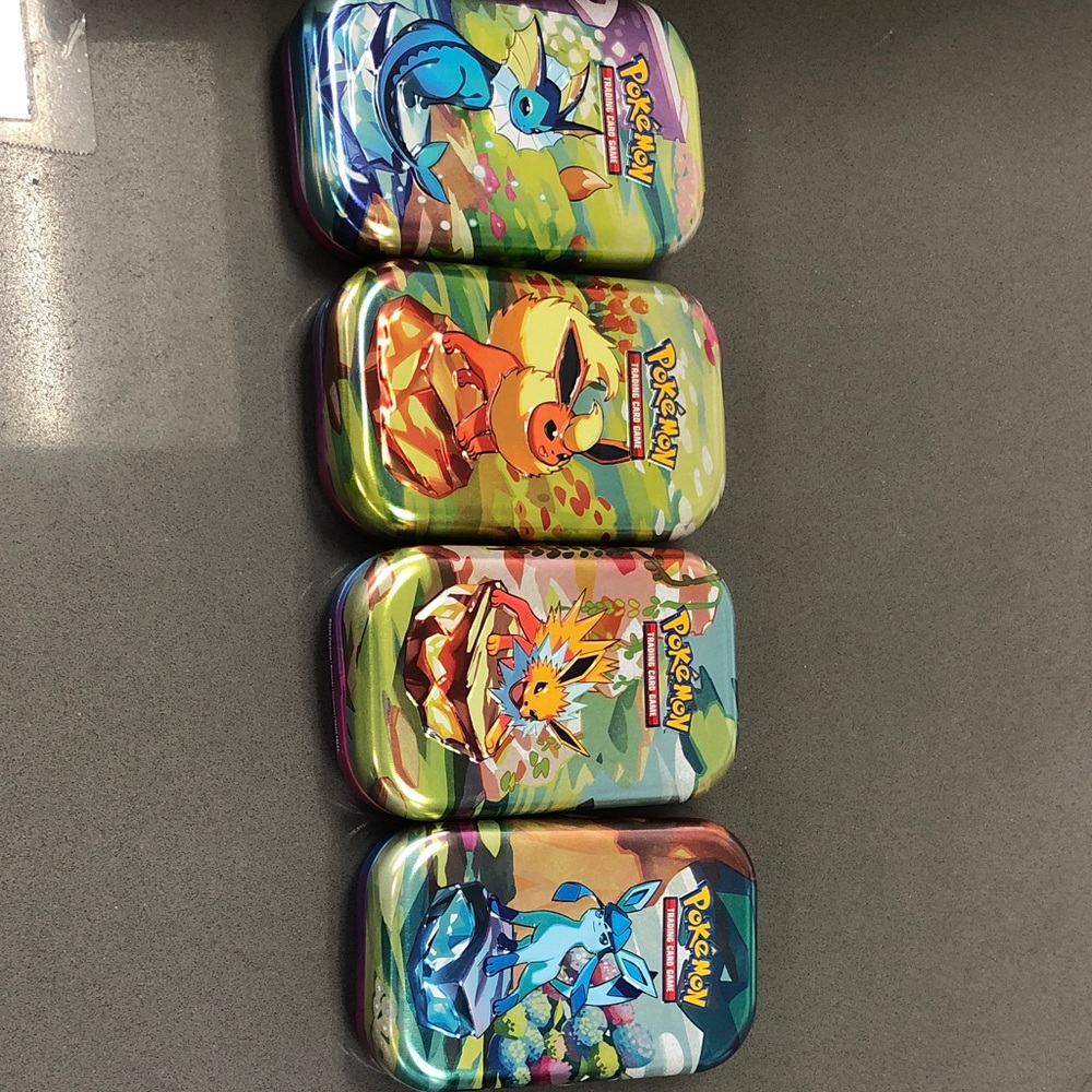 Pokemon Eevee and Evolutions Tin Set - Blue, Green, Orange, Purple
